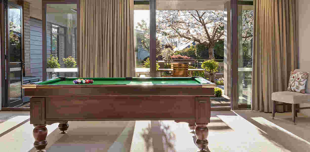 a-pool-table-in-the-room-with-beautiful-view-outside