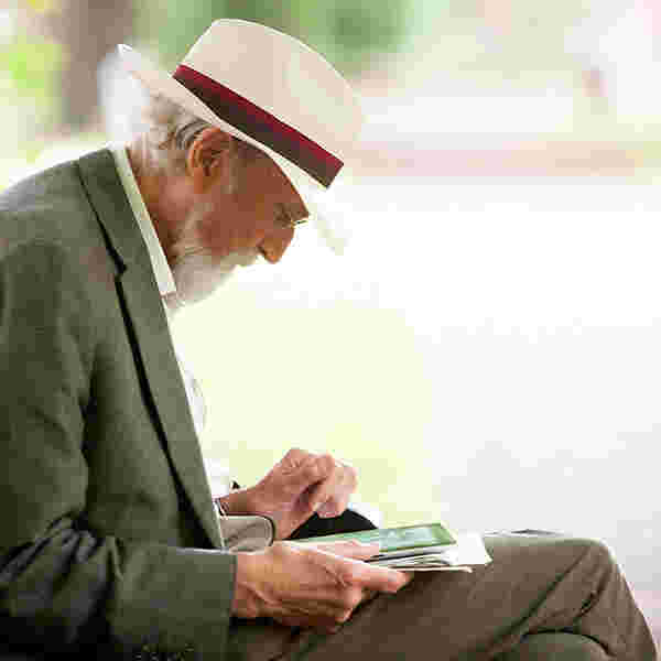 a-senior-reading-sitting-outside