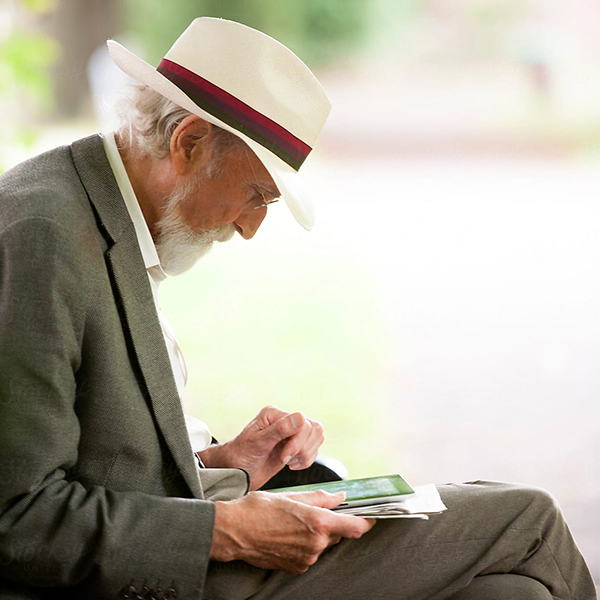 a-senior-reading-sitting-outside